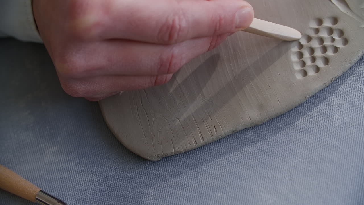 Close-up of a potter working on a piece of clay