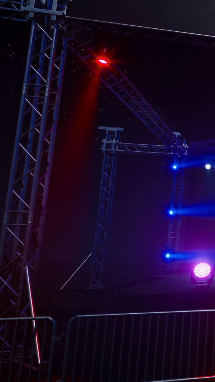 Stage setup for live event with colorful lights and structures in place