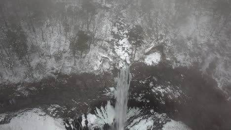 looking down on the frozen mist shrouded kegon falls, nikko, tochigi, japan aerial orbit