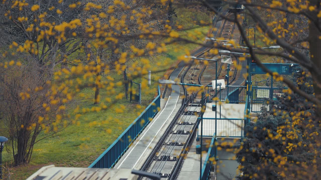 A cable car railway on Prague's Petrin Hill Park framed by the trees