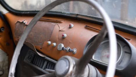 Push-in-view-of-retro-dashboard-on-old-car,-fiat-500,-Bangkok,-Thailand