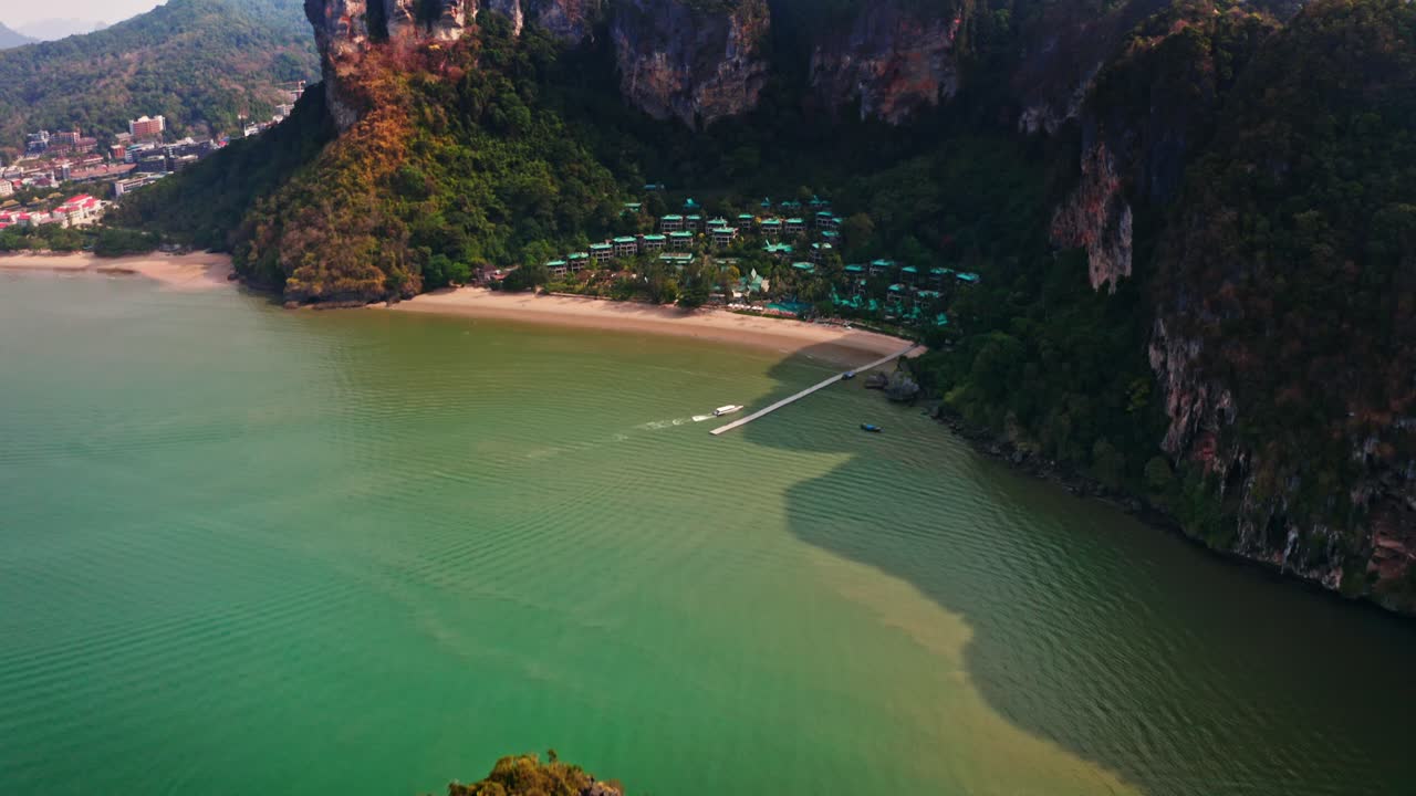Top-down aerial shot of Railay Beach, showing pristine turquoise waters and dramatic rock formations. Ideal for luxury travel, holiday marketing, and nature documentaries.