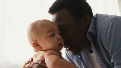 close-up of a father and baby bonding