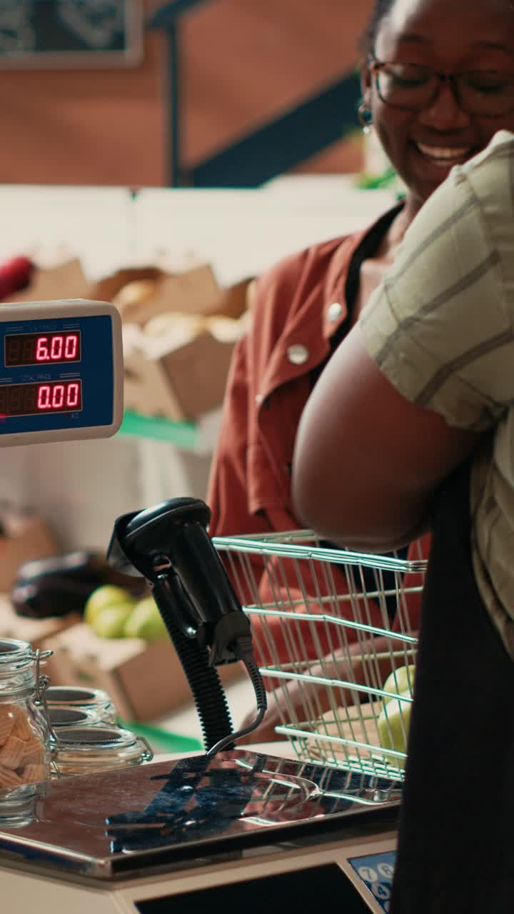 Vertical Video Farmers market owner placing fruits and veggies on scale
