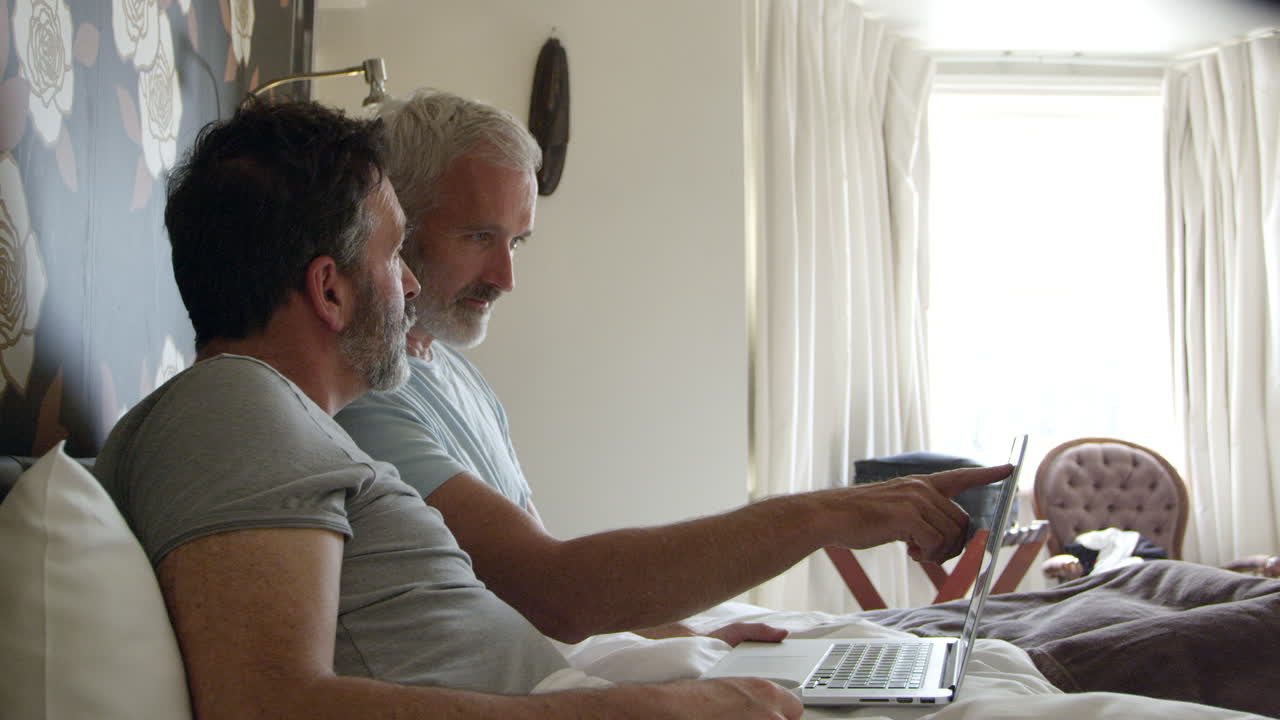 Gay Couple Researching On Laptop In Hotel Room Shot On R3D