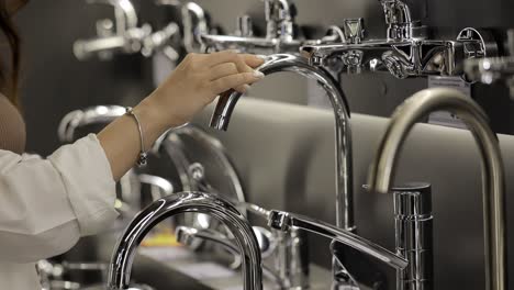 woman shopping for faucets in a home improvement store