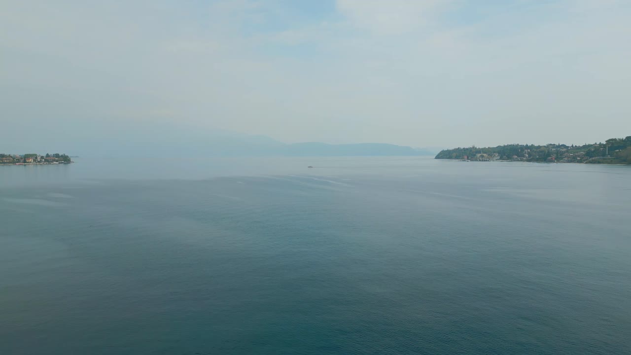 Flying Over Peaceful Water lake Under Blue Sky