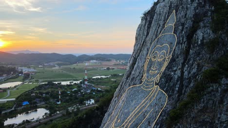 4k aerial medium shot pan left at buddha mountain in pattaya at sunrise