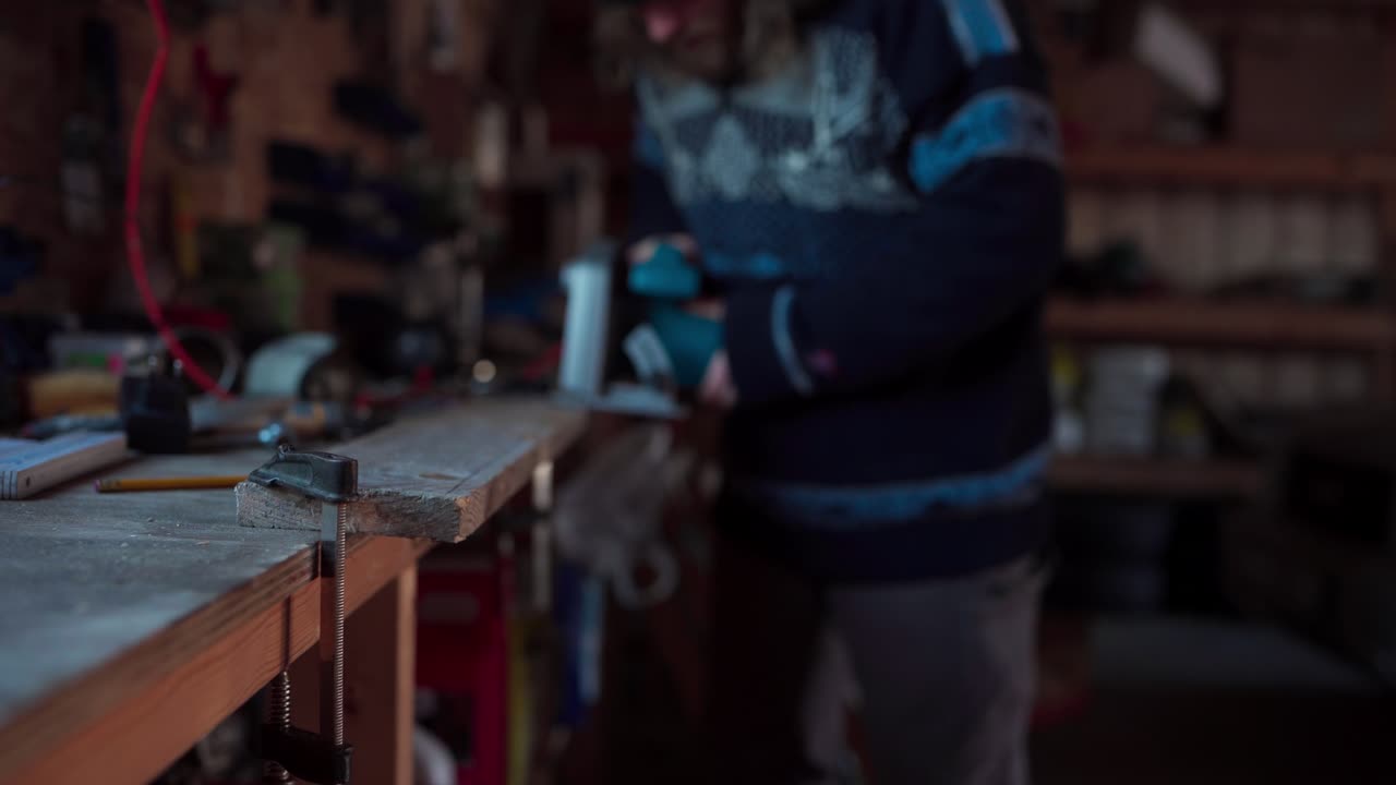 Unrecognizable Man Cutting Wood Plank Using Electrical Cutting Machine