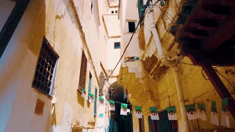 small flag of algeria as a pennant in an alley in the city of algiers