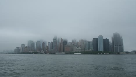 floating on the hudson river looking at manhattan lower east side foggy day in new york city
