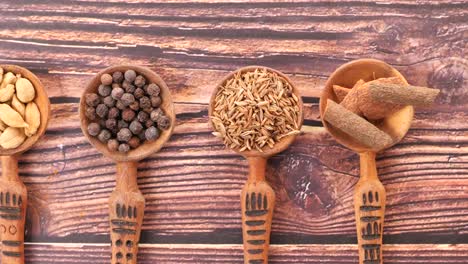 assorted spices in wooden spoons