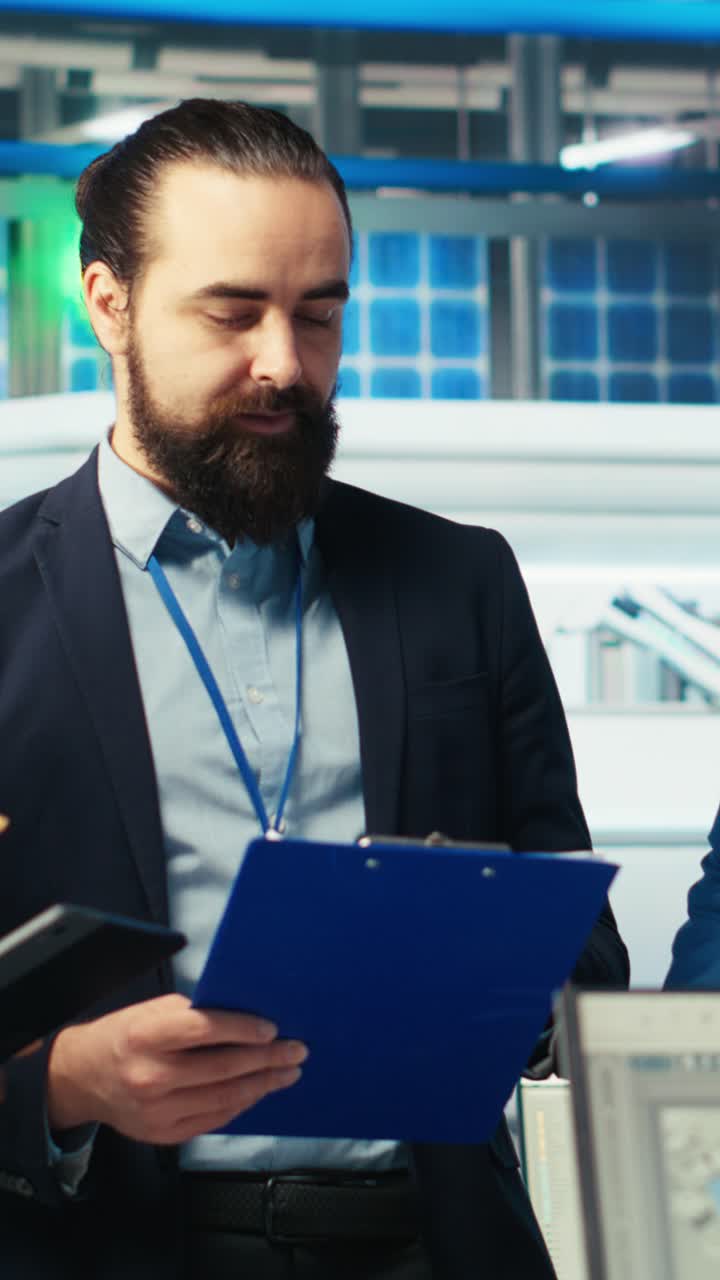 Vertical Video Portrait Of Happy Supervisors Inspecting Solar Plant Machinery