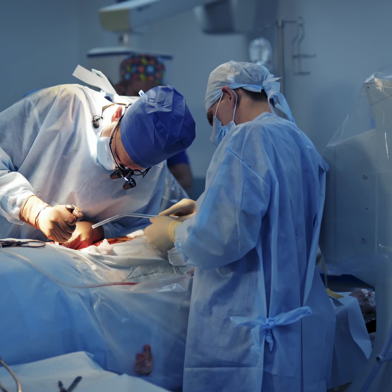 Medical team performing surgical operation in bright modern operating room. Modern equipment in operating room