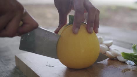 cutting a squash with a chef's knife