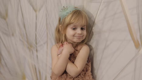 Happy-three-years-old-girl-make-faces-and-dancing.-Cute-blonde-child