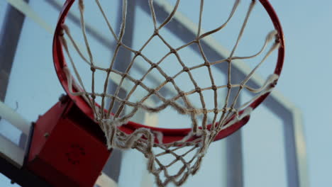 Unknown-person-throwing-ball-into-basket-in-sport-playground-outdoors.