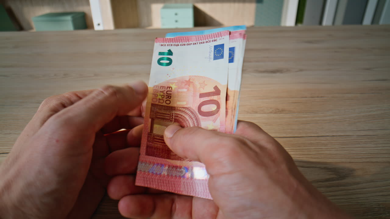 Hands counting pack euro bills receiving salary at business workplace closeup