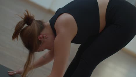 woman practicing yoga forward fold