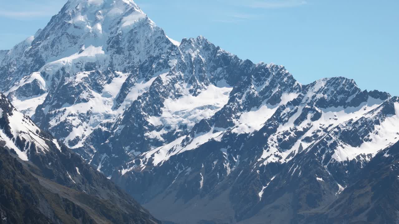 Detail view of Mount Cook's snowy peak on a clear sunny summer day in Mount Cook National Park, New Zealand.