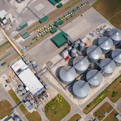 grain silos on agricultural land. steel grain elevators. storage containers for crop. agriculture industry. top aerial view
