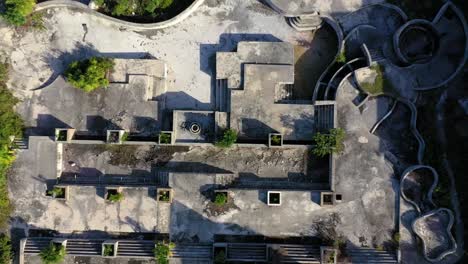 video de drone de ascenso vertical de una ruina de un hotel de lujo en una playa tropical después de la destrucción por un huracán