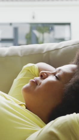 video of plus size african american woman relaxing on sofa