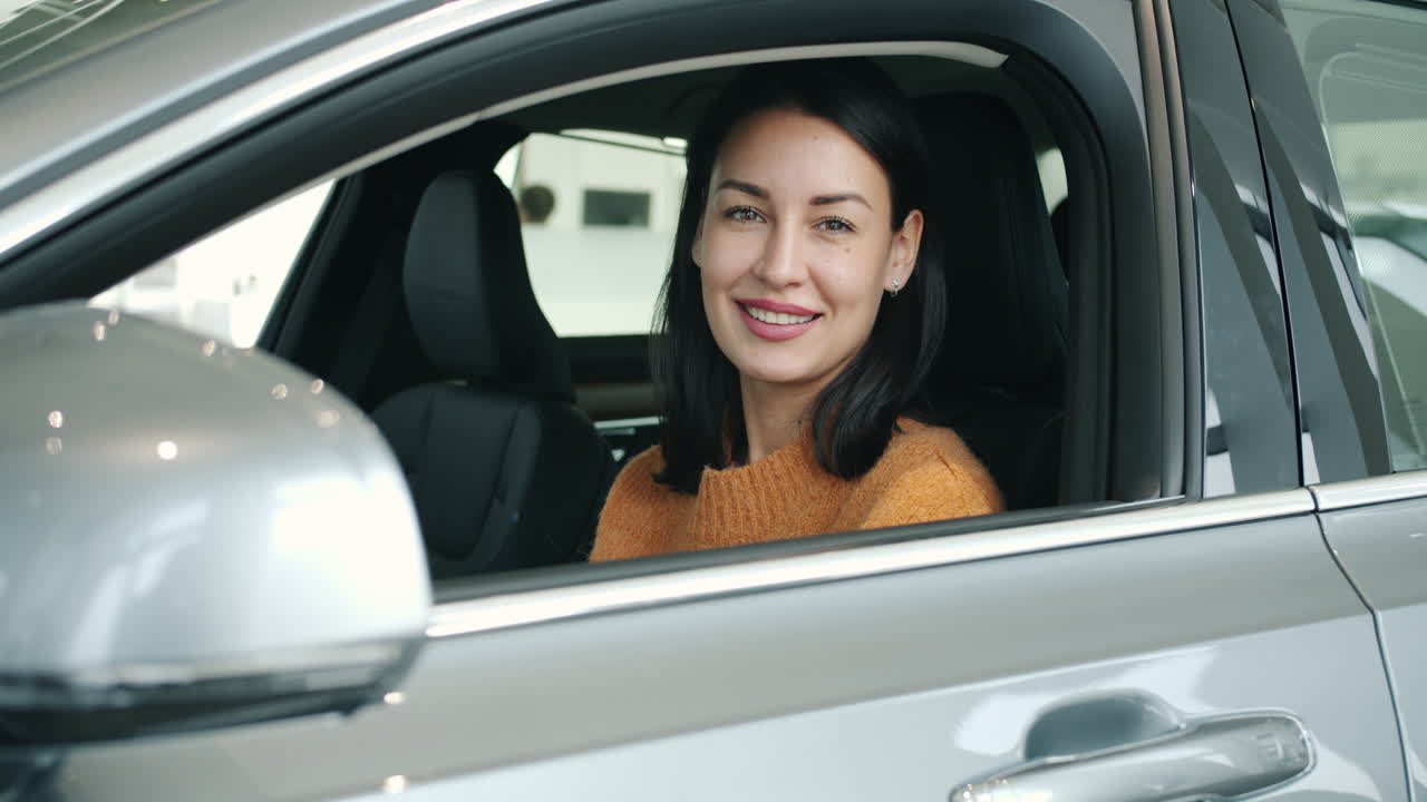 Woman Smiling in a Car Showroom