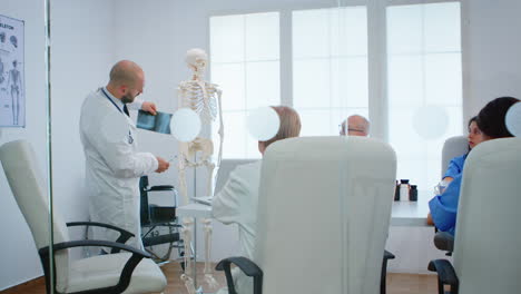 physician learning colleagues body bone functionson using x-ray and human skeleton