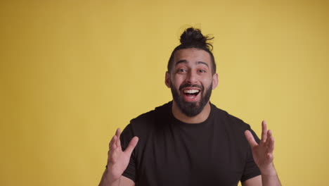 studio portrait of young man celebrating good news standing against yellow background 1