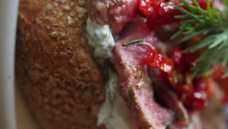 grilled steak with creamy sauce and roasted tomatoes on bread