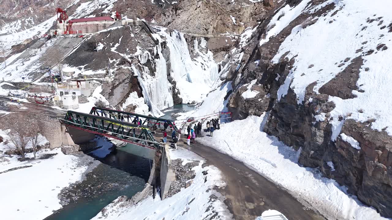 Frozen Waterfall and Bridge in the Mountains