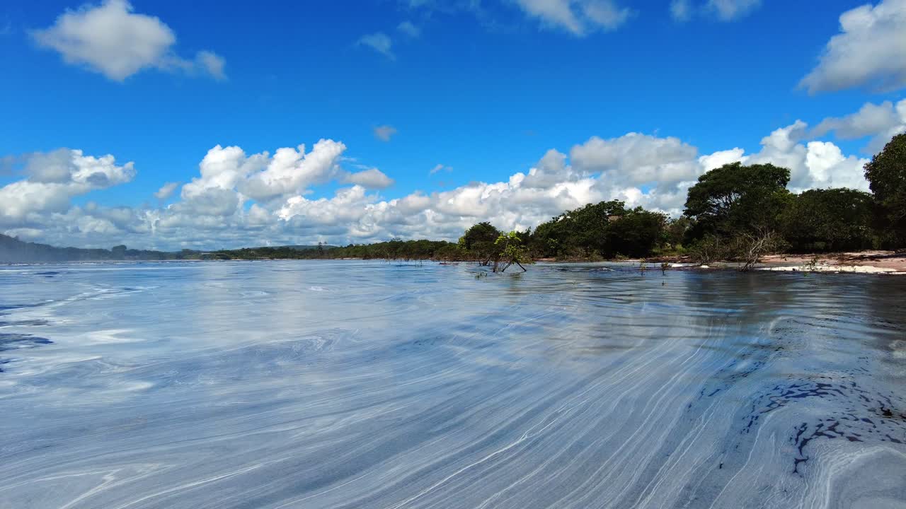 Panoraamakuva rehevästä maisemasta Canaiman laguunin rannalla, vaahtoa veden lähellä, Venezuela.