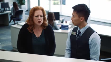 Intense Conversation at the Service Desk: A Dramatic Exchange Between a Customer and a Representative in a Busy Office Environment
