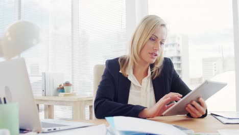 businesswoman using digital tablet at her desk