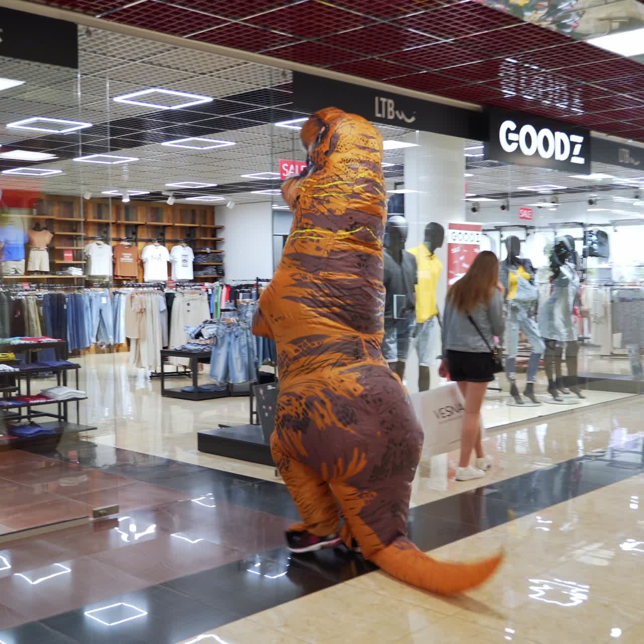 Crazy lifestyle halloween dragon suit. Funny person in dino costume