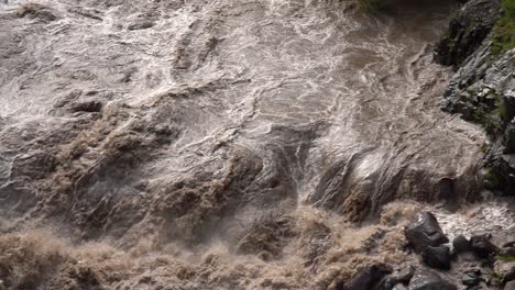 raging flooded river flowing in slow motion