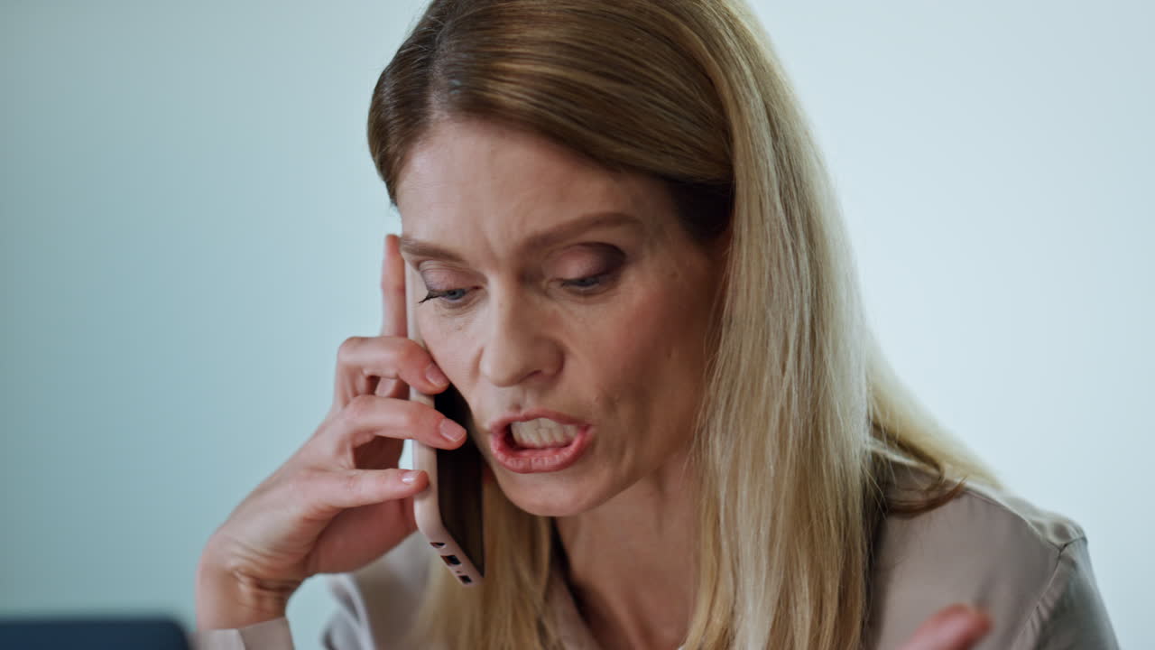 Nervous manager talking phone at work portrait. Furious woman gesturing hands
