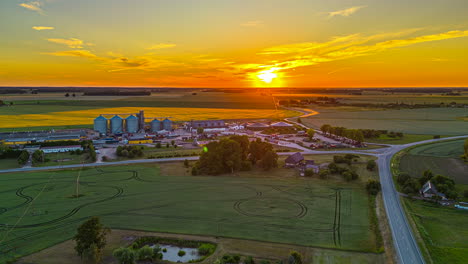grain silo at sunset in a farming community - pullback aerial hyper lapse