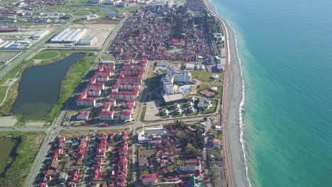 aerial view of coastal city with hotels and residential buildings