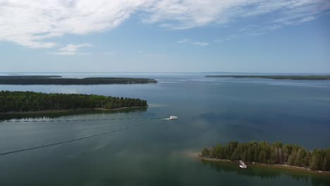 aerial shot of lake archipelago with lone yacht boat - les cheneaux islands, michigan
