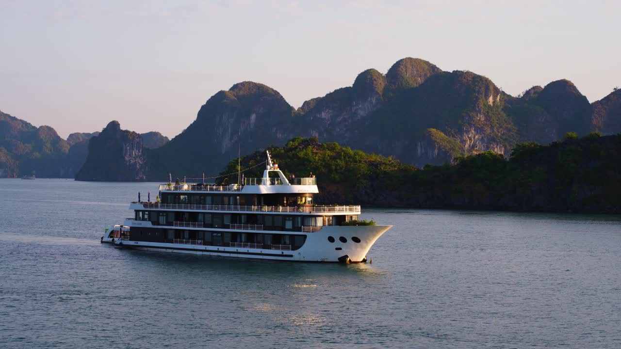 Luxury cruise ship touring at Ha Long Bay during sunrise, Vietnam