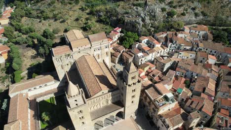 aerial footage by drone, circulating the cefalu cathedral in sicily, italy