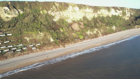 scenic aerial view of branscombe beach, cliffs, and coastal houses by the english channel.