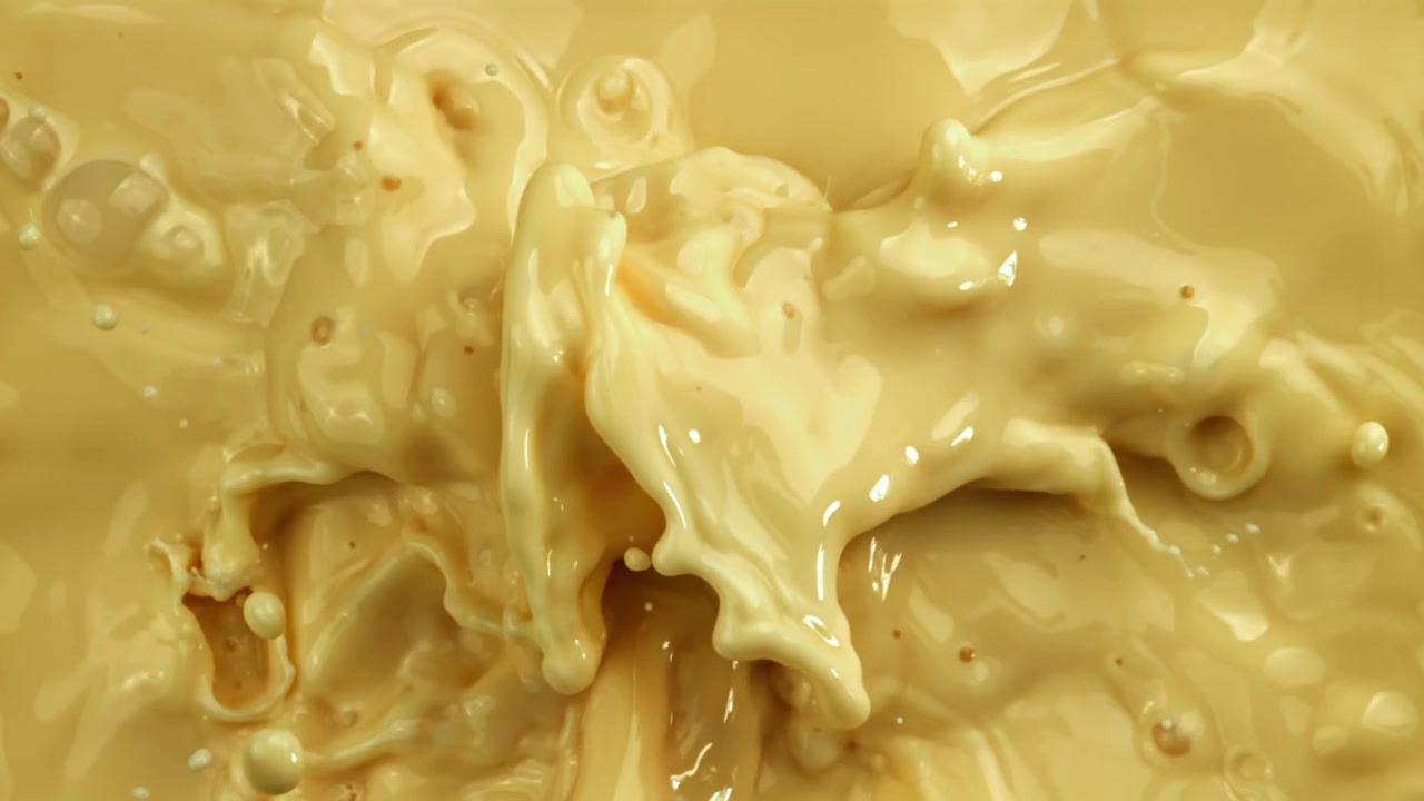 Slow Motion Splash of Creamy Yellow Liquid with Ripples