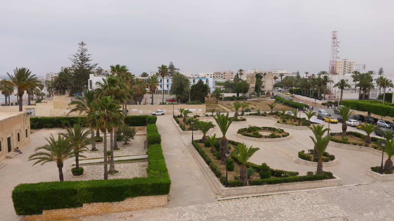Beautiful view on palm and flower beds in city park Baladia in Monastir, Tunisia