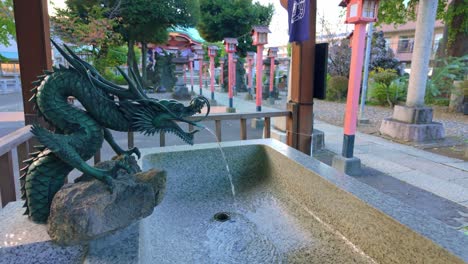 Dragon-Water-Fountain-with-Shrine-Temple-in-The-Background-in-Tokyo-Japanese