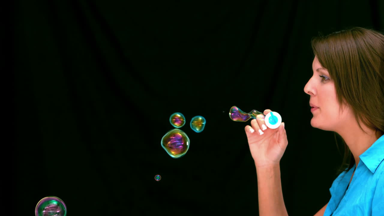 Brunette woman blowing bubbles