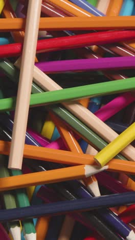 Vertical-Video-Full-Frame-Close-Up-Shot-Of-Rotating-Multi-Coloured-Pencils-