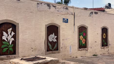 colorful street art: flowers painted on old building doors